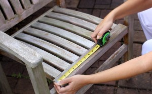 While your friend is out of the room, quickly whip out your tape measure and take the dimensions of the furniture's seat width and depth. (Width measurement shown.)